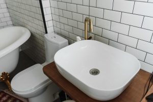 Bathroom wall with tiled pattern and grout, awaiting grout recoloring for a refreshed look